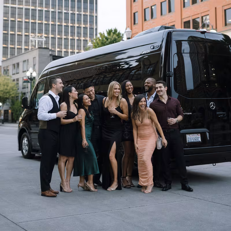 Group boarding a white charter bus for Bachelor & Bachelorette Transportation transportation in Tacoma