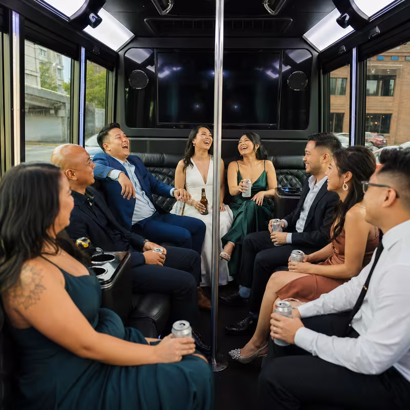 Party bus interior with wraparound leather seating and LED lighting in Tacoma