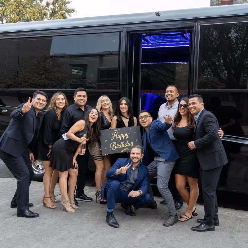 Group boarding a white charter bus for Birthday Transportation transportation in Tacoma