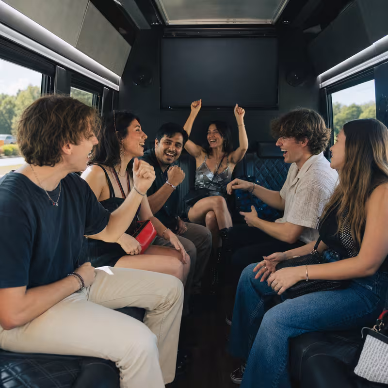 Group boarding a white charter bus for Concert Transportation transportation in Tacoma