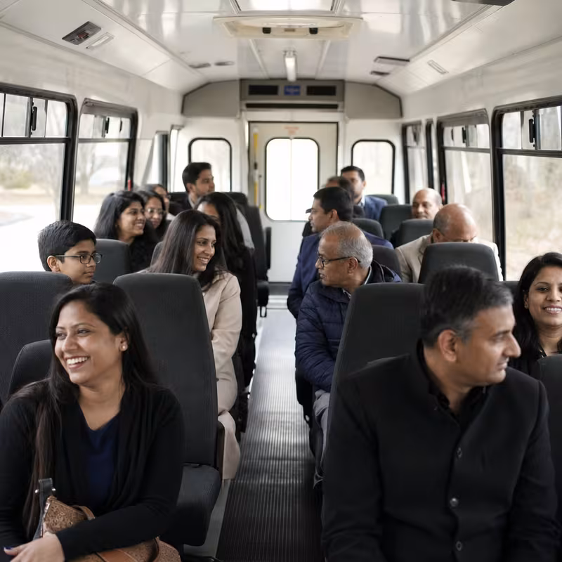 Group boarding a white charter bus for Private Event Transportation transportation in Tacoma