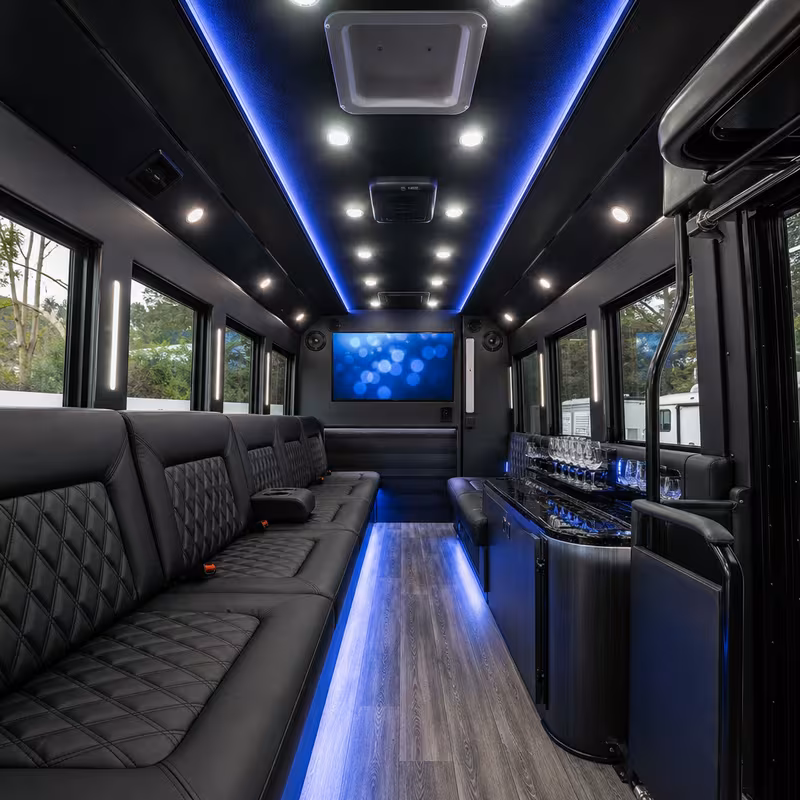 Party bus interior with wraparound leather seating and LED lighting in Tacoma