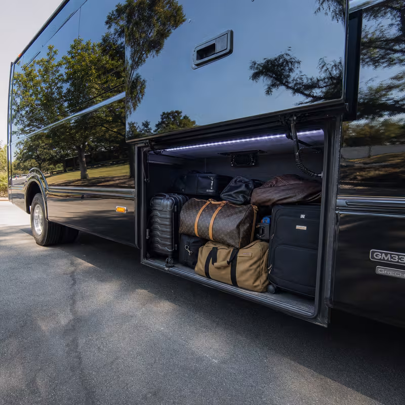 Party bus interior with wraparound leather seating and LED lighting in Tacoma