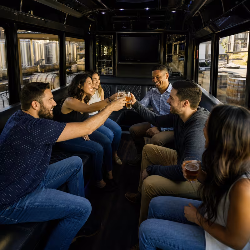 Group boarding a white charter bus for Winery & Brewery Tour Transportation transportation in Tacoma