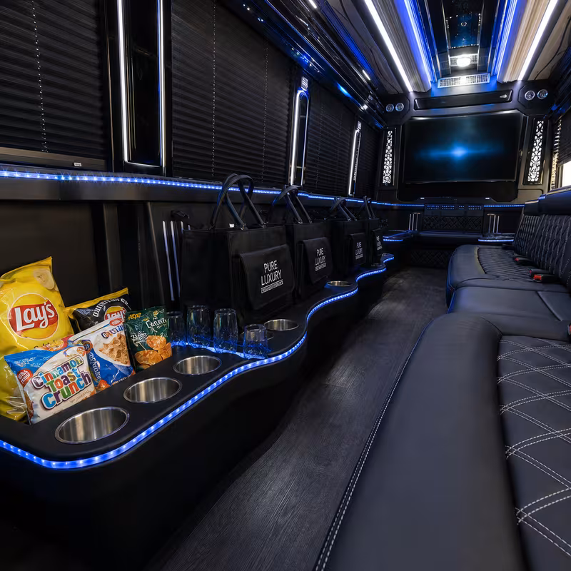 Party bus interior with wraparound leather seating and LED lighting in Tacoma